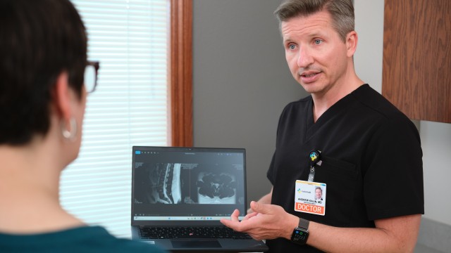 Doctor showing patient an xray on the computer