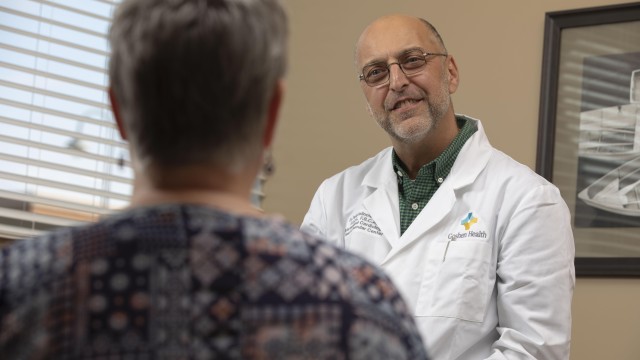 Doctor in a white coat talking to patient