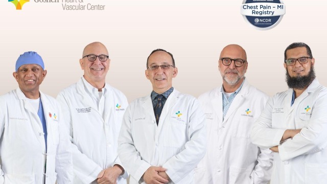 Five doctors standing next to each other in white lab coats