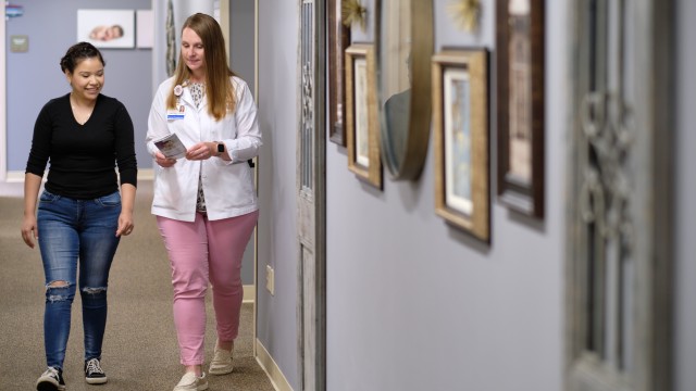Doctor and patient walking down a hallway