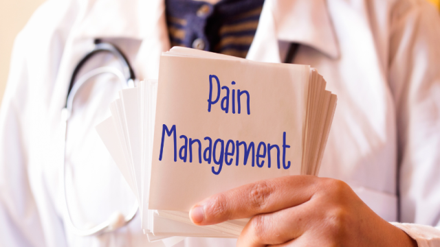 Doctor holding a sign that says, pain management