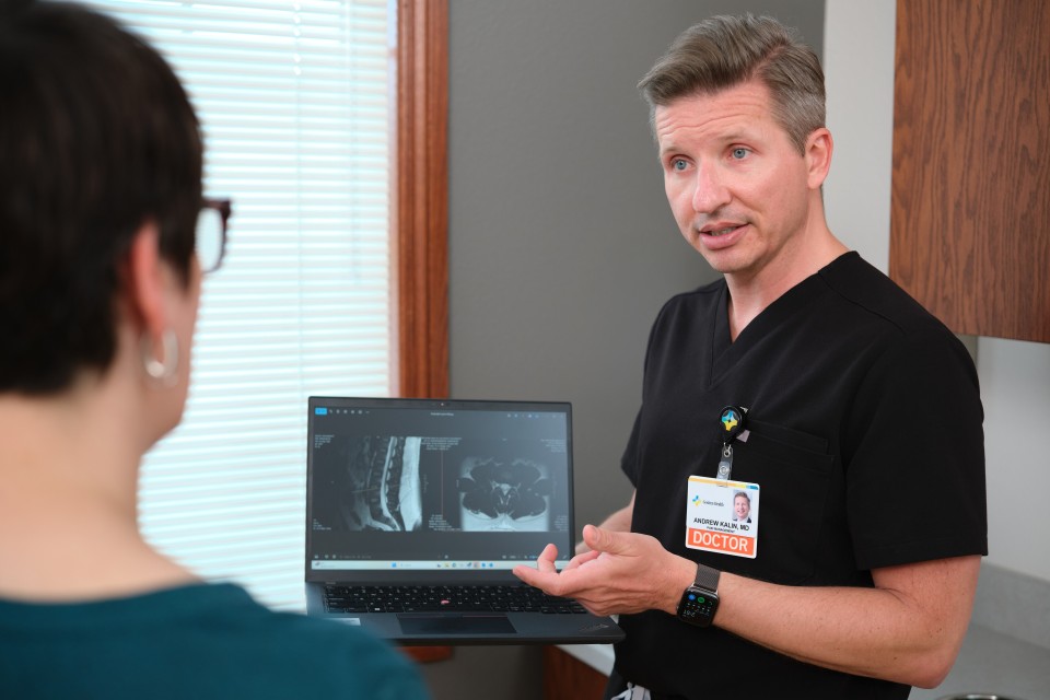 Doctor showing patient an xray on the computer