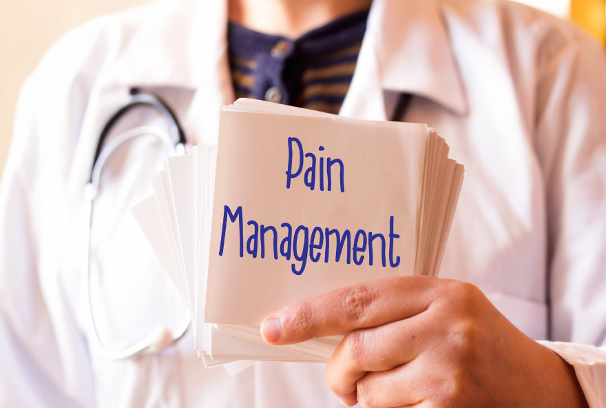 Doctor holding a sign that says, pain management
