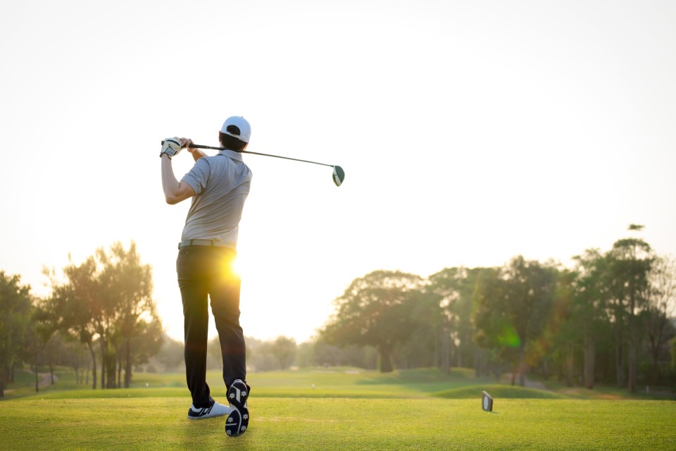 Man swinging a golf club