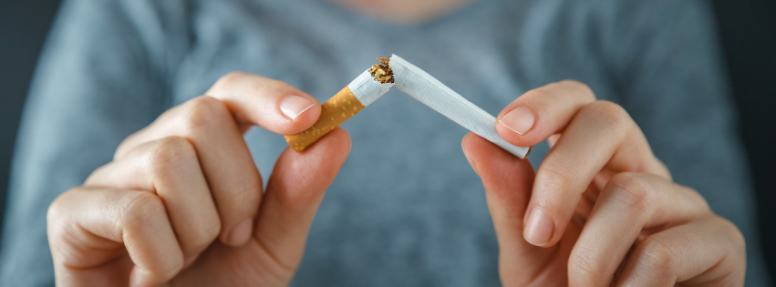Two hands holding a broken cigarette