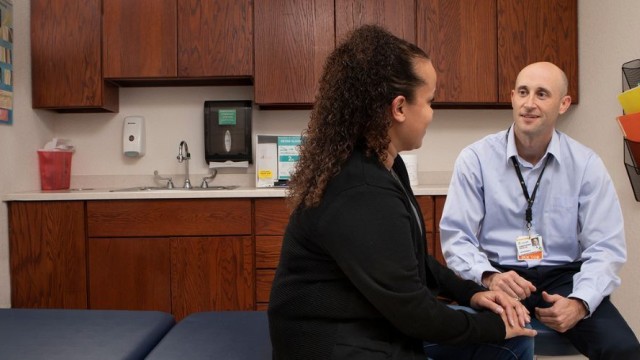 Doctor and patient sitting in an exam room talking
