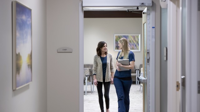 Patient and doctor standing in a doorway