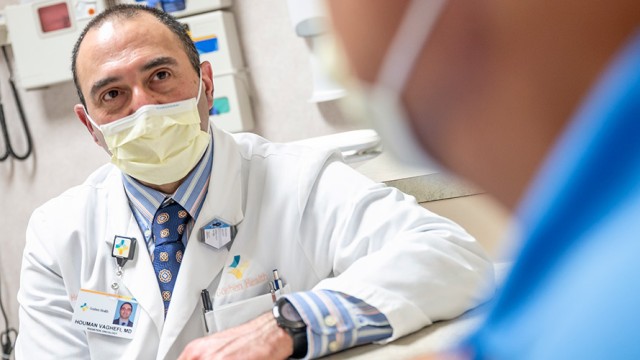 Doctor and patient in an exam room, both wearing masks