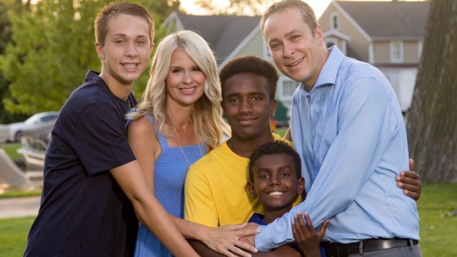 Family standing in a hugging pose