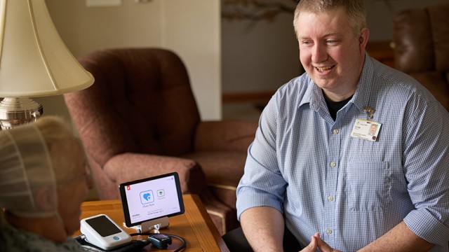 Doctor sitting across from patient with a small monitor on the table