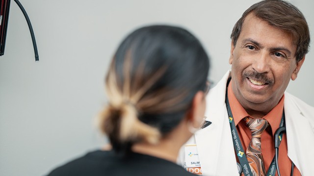 Doctor smiling while facing a patient