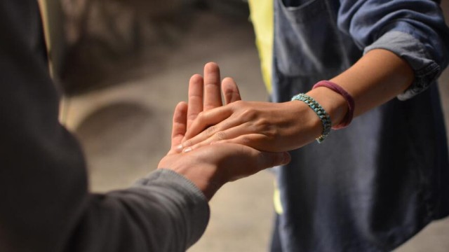 Elderly people holding hands