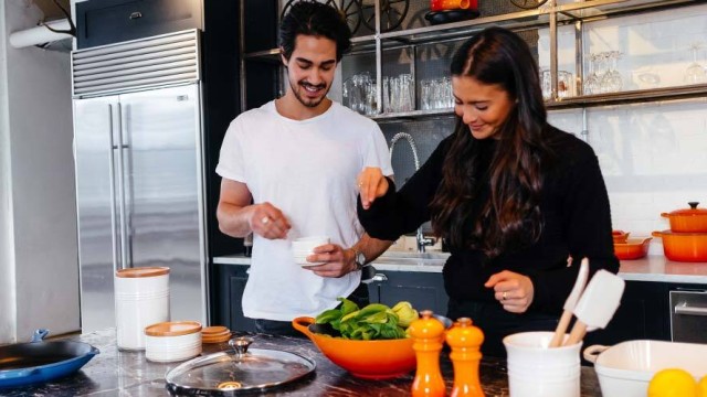 Man and woman cooking healthy food in a kitchen