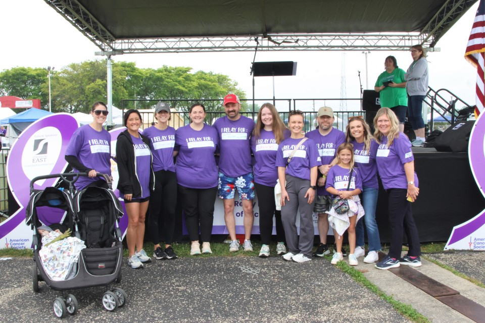 Group of people standing in front of a stage