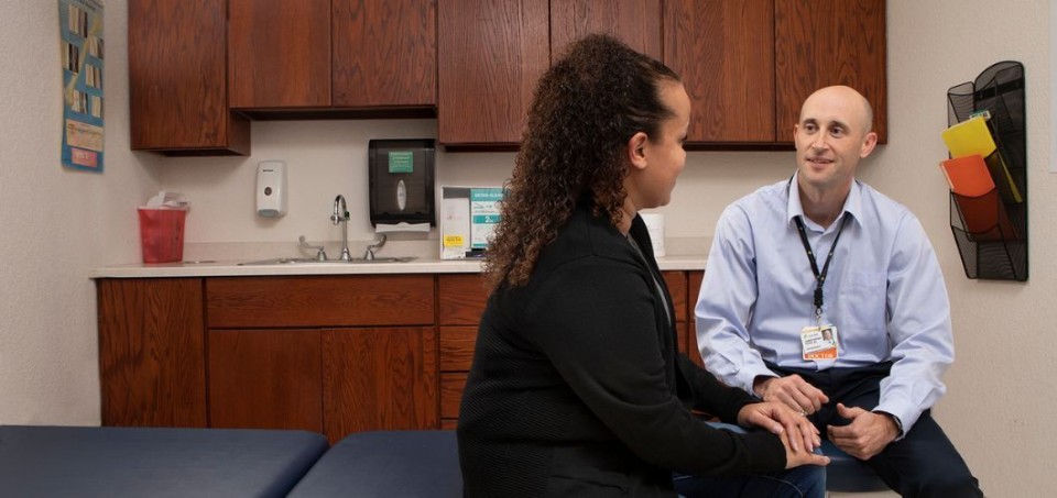 Doctor and patient sitting in an exam room talking