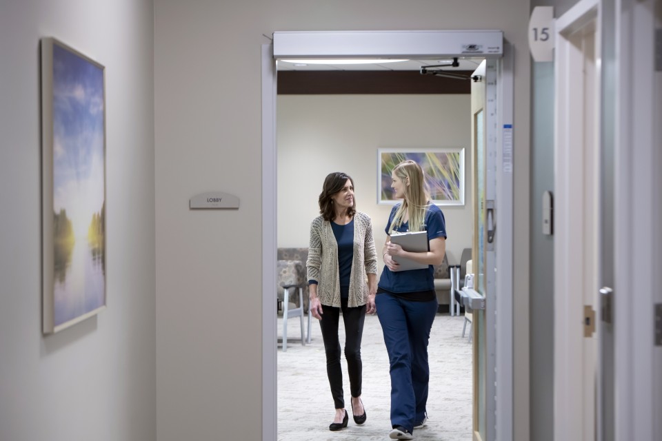 Patient and doctor standing in a doorway