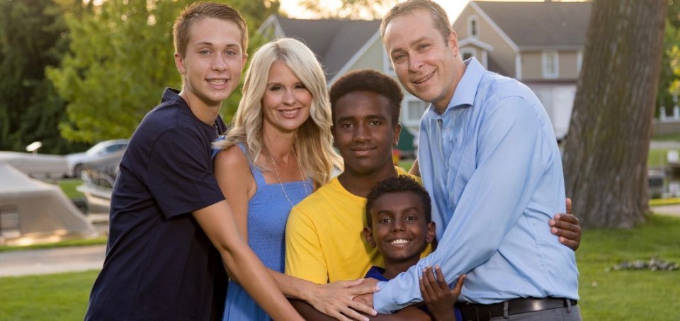 Family standing in a hugging pose