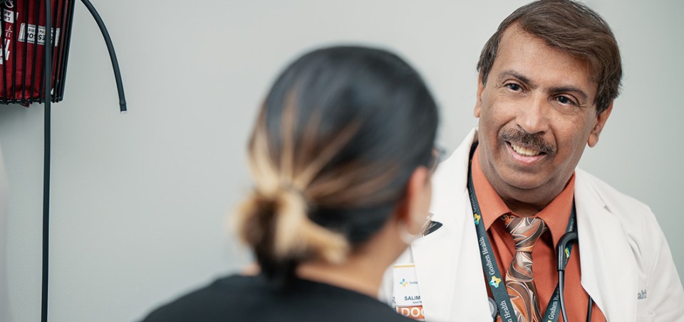 Doctor smiling while facing a patient