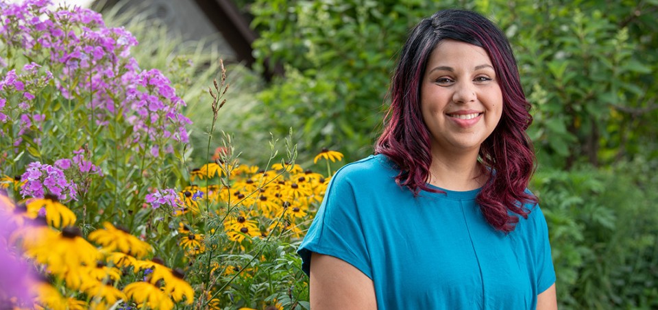 Woman smiling with flowers in the background