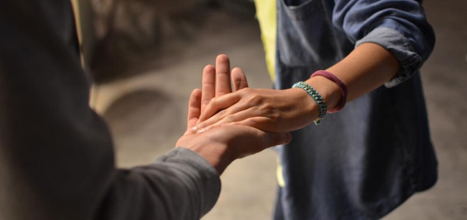 Elderly people holding hands