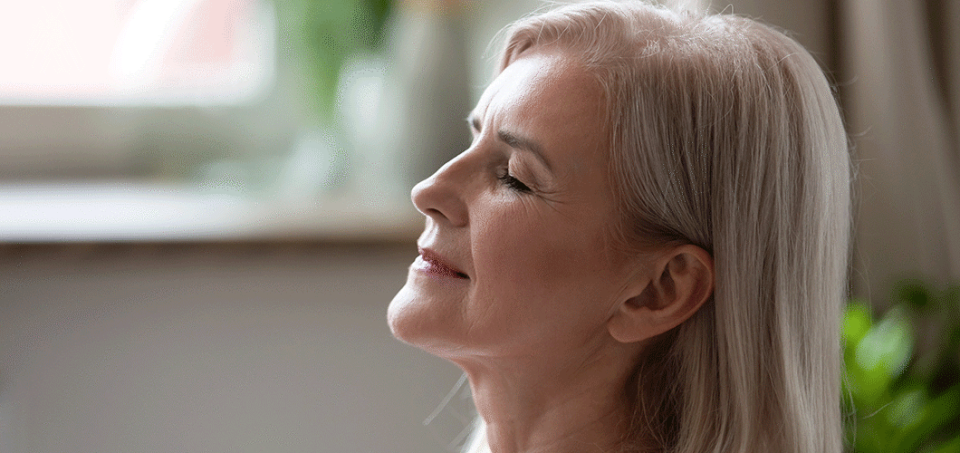 Profile of older woman relaxing with her eyes closed