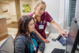 Goshen Health Colleagues looking at a computer screen