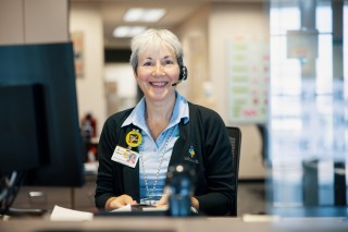 Colleague sitting at her desk, smiling