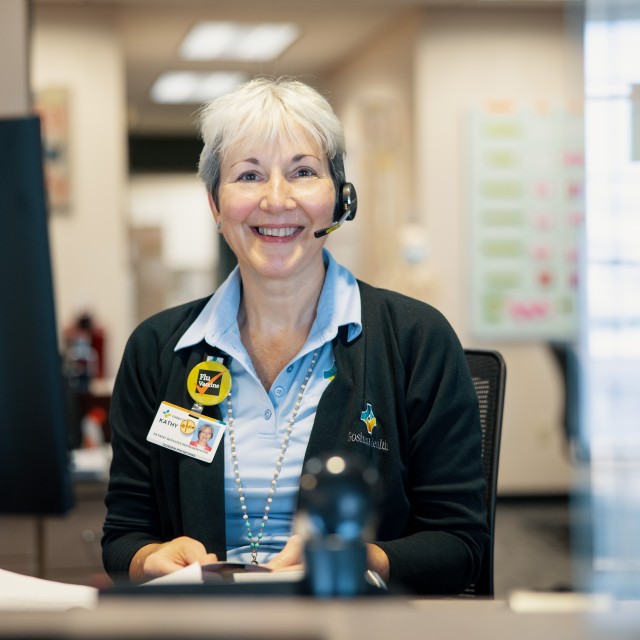 Colleague sitting at her desk, smiling