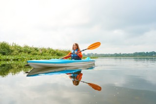 Woman kayaking on a pond