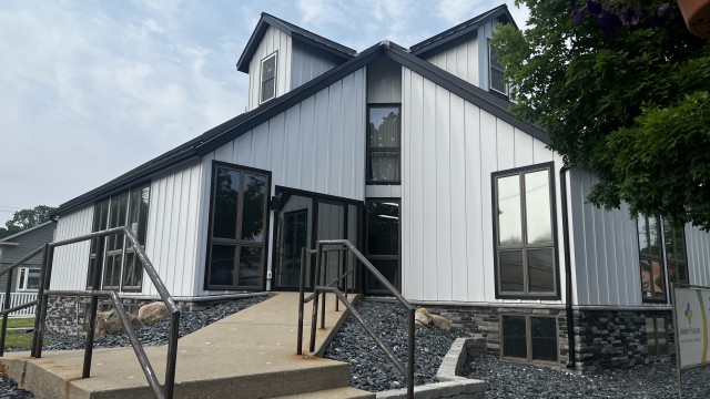 Sidewalk leading up to odd shaped building