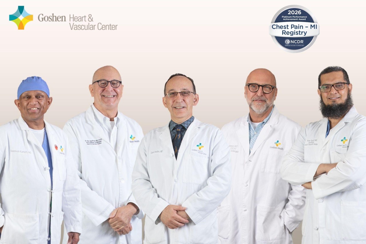 A group of doctors in white lab coats standing shoulder to shoulder