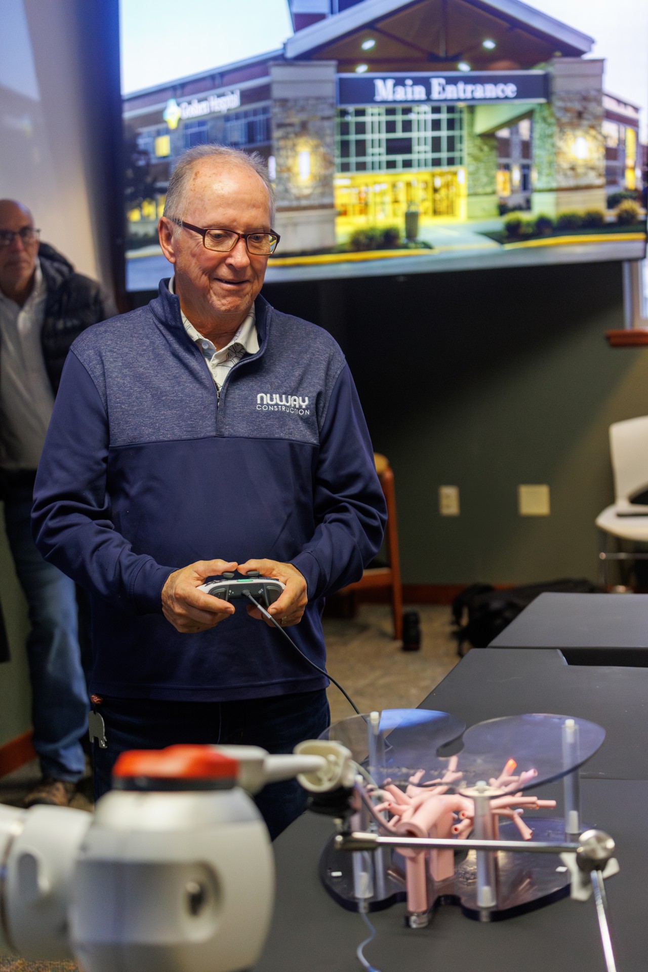 A man standing holding a controller running the galaxy robot
