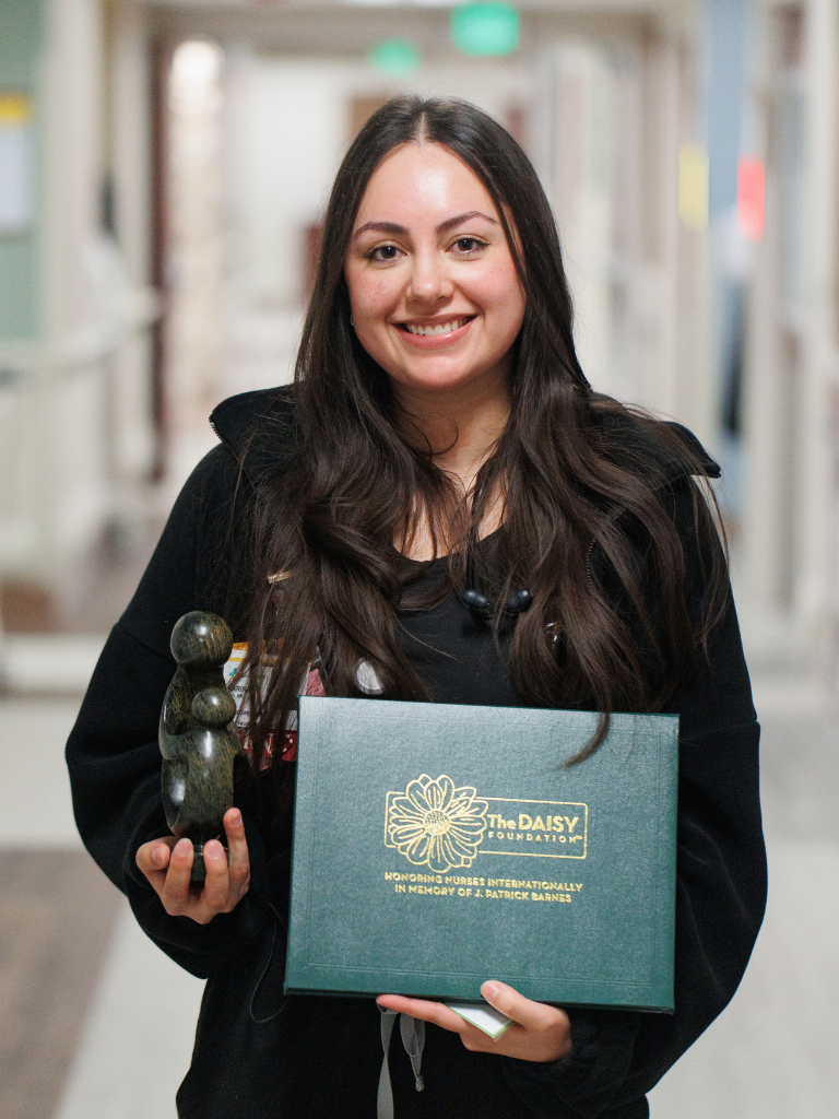 DAISY award winner holding awards