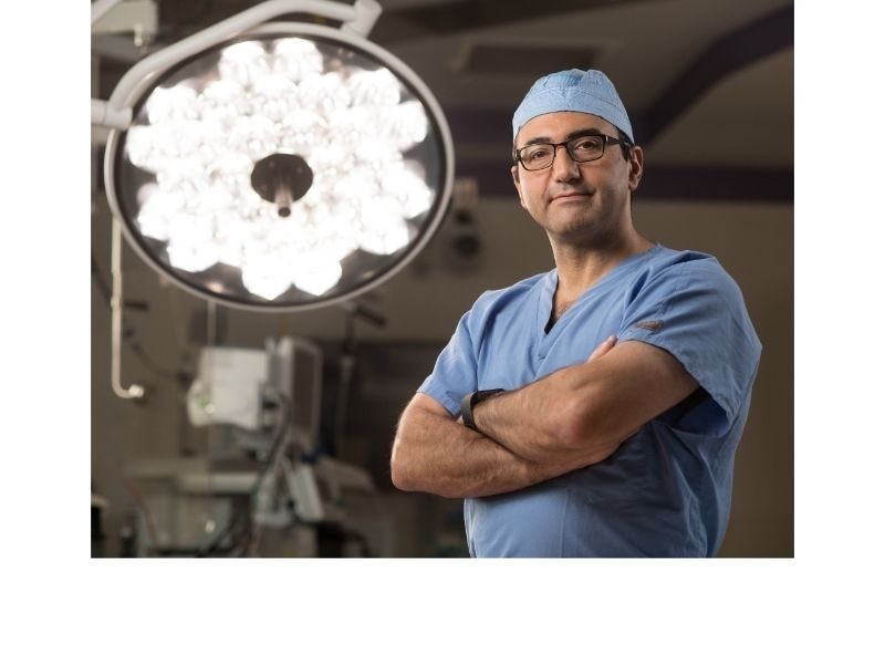 Doctor standing in the operating room with his arms crossed