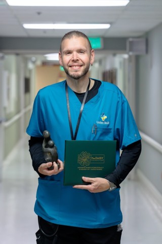 Will Grant holding a DAISY Award