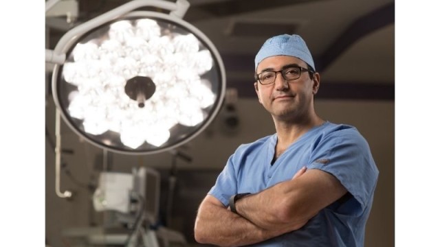 Doctor standing in the operating room with his arms crossed