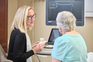 Doctor discussing care with a patient sitting at a desk