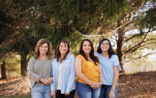 Four women standing together outdoors