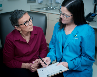 A doctor and patient talking in an exam room