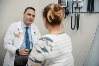 Doctor and patient sitting in an exam room talking