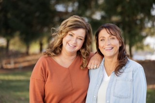 Two women standing together outdoors