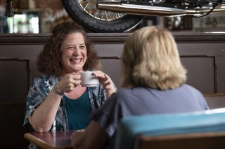 Friends having coffee in a booth