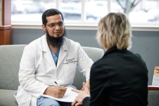 Doctor and patient sitting on a couch, facing each other