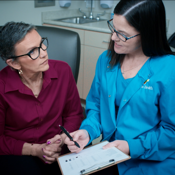 A doctor and patient talking in an exam room