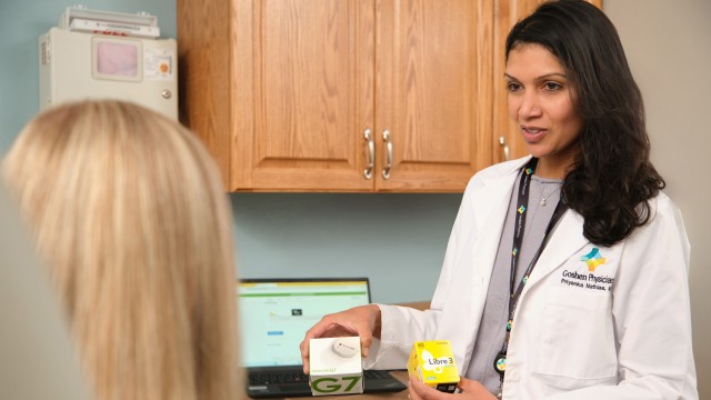 Doctor showing a patient some boxes