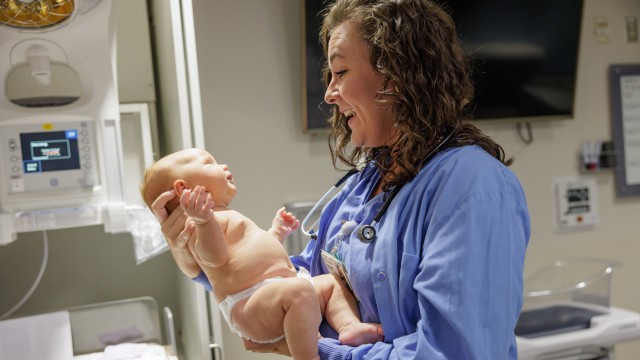 Nurse holding a newborn baby