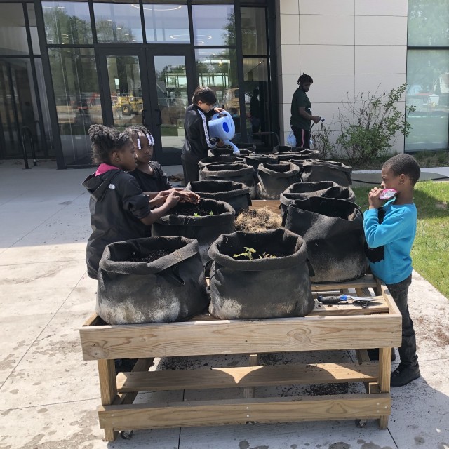 Children planting mobile gardens at the Tolson Center