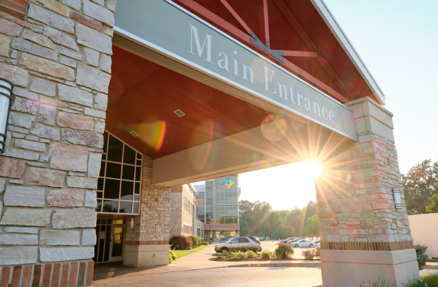 Main entrance to Goshen Hospital with a sun beam