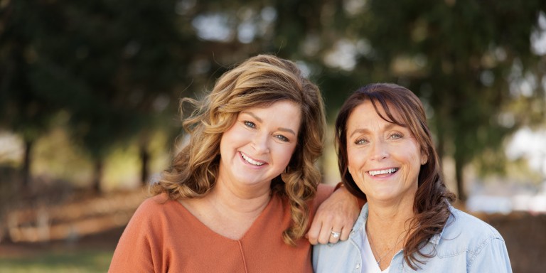 Two women standing together outdoors