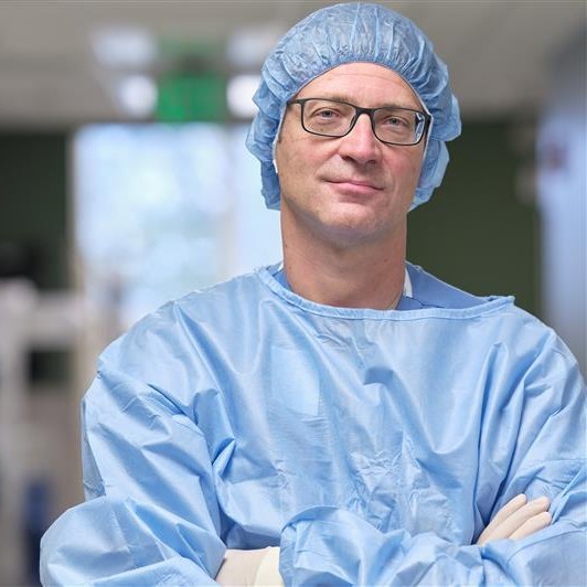 Doctor in scrubs standing in a surgical room